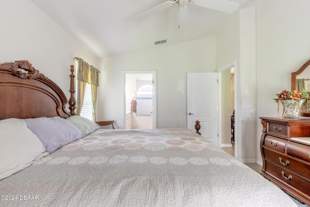 bedroom featuring light colored carpet, lofted ceiling, ceiling fan, and connected bathroom