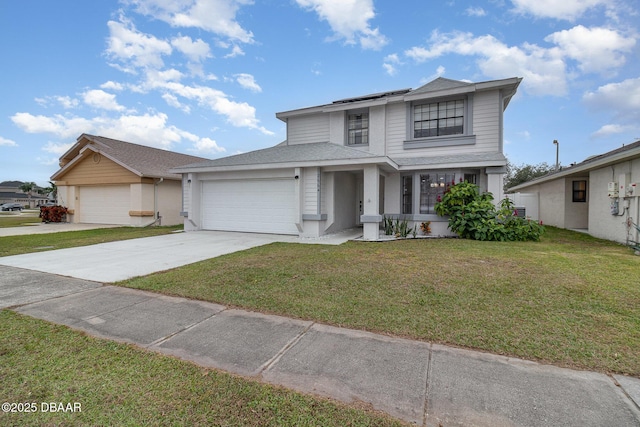 view of front of property with a front yard and a garage