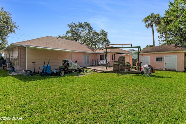 410 S Beach St, Ormond Beach, FL 32174 - rear view of house featuring a lawn, a deck, an outbuilding, and french doors
