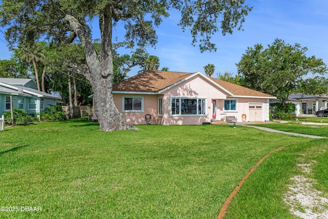 410 S Beach St, Ormond Beach, FL 32174 - view of front of house with a garage, a front lawn, stucco siding, and driveway