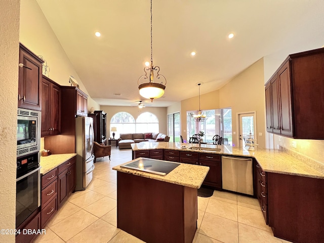 kitchen with pendant lighting, lofted ceiling, stainless steel appliances, light stone counters, and kitchen peninsula