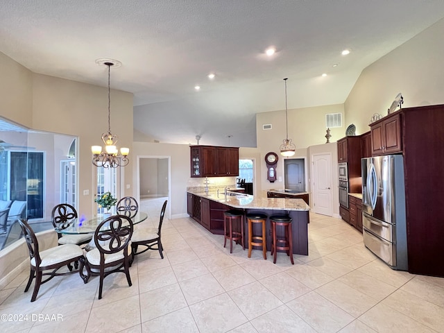 tiled dining room with high vaulted ceiling, sink, and a chandelier