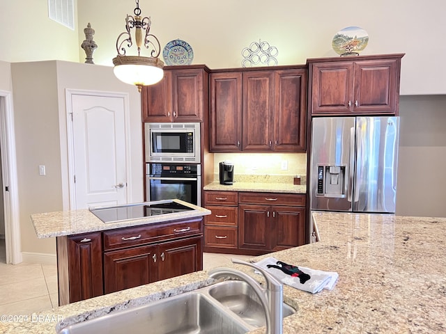 6382 Longlake Dr, Port Orange, FL 32128 - kitchen featuring stainless steel appliances, a sink, pendant lighting, light tile patterned flooring, and light stone counters
