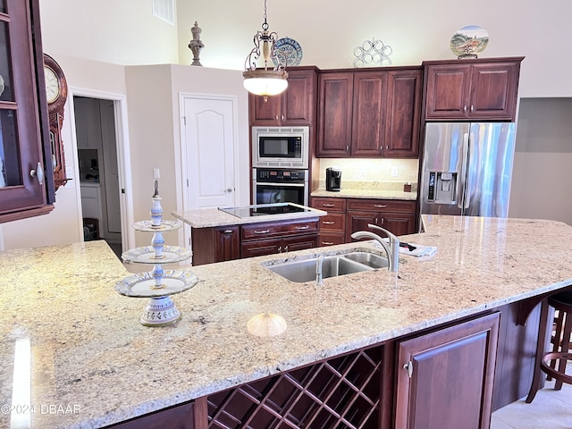 6382 Longlake Dr, Port Orange, FL 32128 - kitchen with appliances with stainless steel finishes, a sink, a kitchen island, light stone counters, and a kitchen breakfast bar