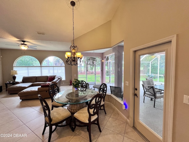 dining space with light tile patterned flooring, a chandelier, vaulted ceiling, and a wealth of natural light