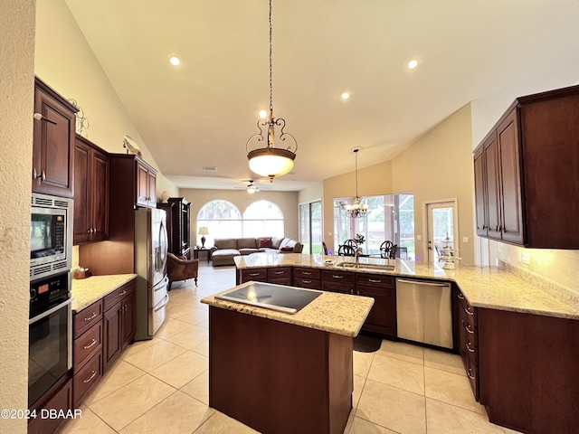 kitchen featuring appliances with stainless steel finishes, hanging light fixtures, light stone countertops, vaulted ceiling, and kitchen peninsula