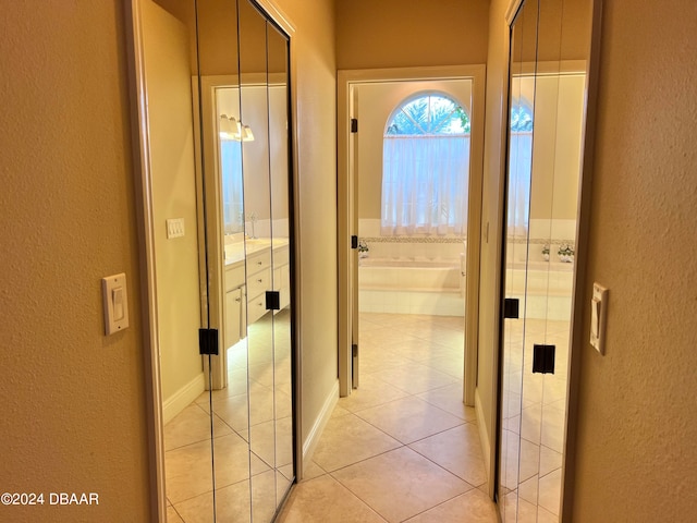 corridor featuring light tile patterned flooring