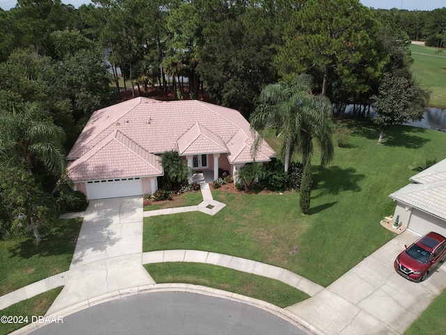 6382 Longlake Dr, Port Orange, FL 32128 - view of front of property with concrete driveway, an attached garage, a tile roof, and a front lawn