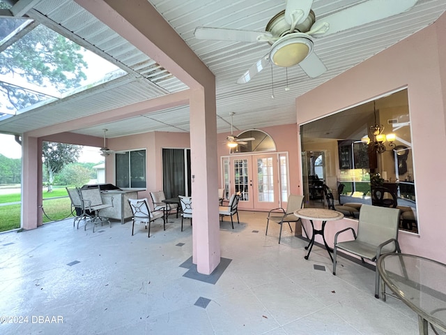 view of patio / terrace with exterior bar, ceiling fan, and french doors