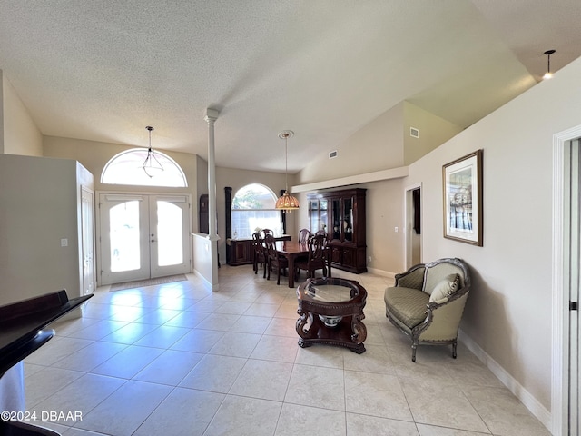 6382 Longlake Dr, Port Orange, FL 32128 - entryway featuring french doors, light tile patterned floors, vaulted ceiling, and a textured ceiling
