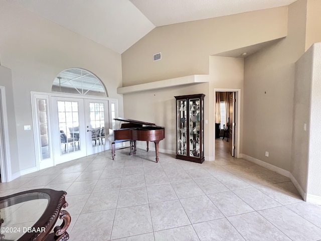6382 Longlake Dr, Port Orange, FL 32128 - foyer featuring french doors, light tile patterned floors, high vaulted ceiling, and baseboards