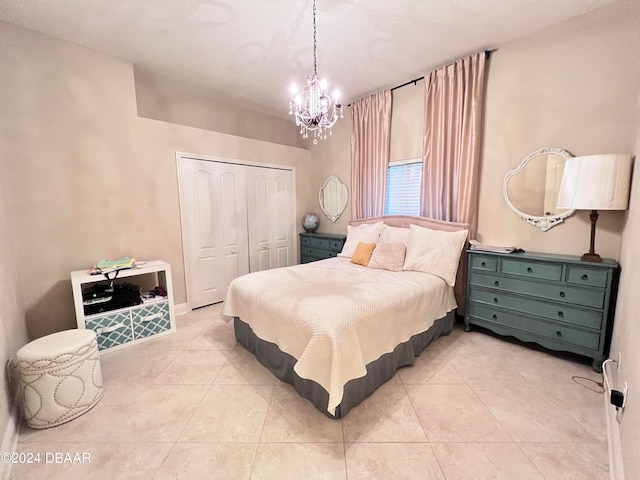 tiled bedroom with a closet and a notable chandelier