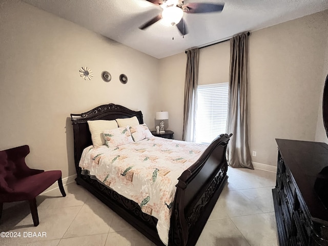 6382 Longlake Dr, Port Orange, FL 32128 - bedroom with light tile patterned flooring, a textured ceiling, a ceiling fan, and baseboards
