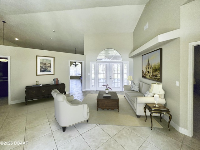 living room with light tile patterned floors, high vaulted ceiling, and french doors