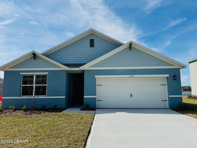 view of front of house featuring a garage and a front yard