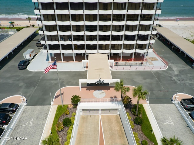 drone / aerial view featuring a beach view and a water view