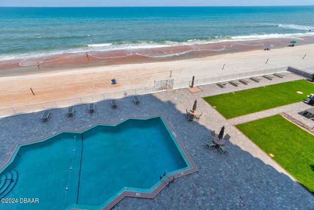 birds eye view of property with a water view and a view of the beach