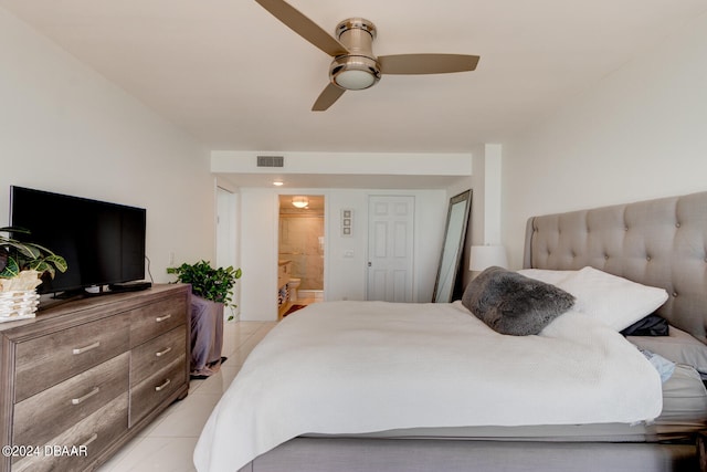 tiled bedroom featuring ensuite bathroom and ceiling fan