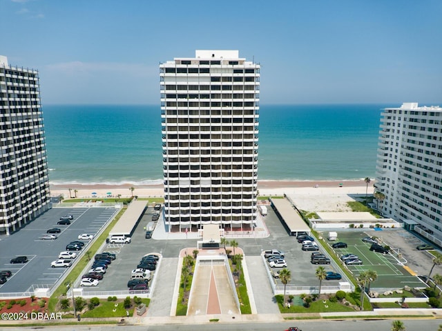 birds eye view of property featuring a beach view and a water view