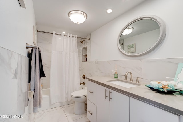 full bathroom featuring vanity, toilet, shower / bath combo with shower curtain, and tile walls