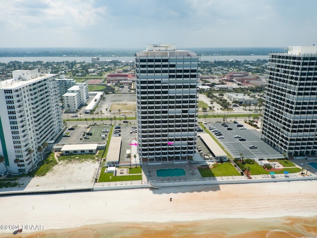 birds eye view of property with a beach view and a water view