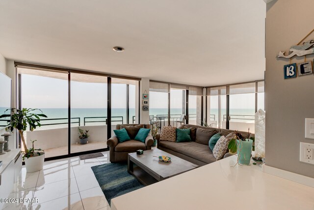 living room with a water view and light tile patterned floors