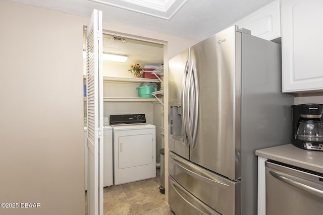 kitchen featuring white cabinetry, appliances with stainless steel finishes, and washer / dryer