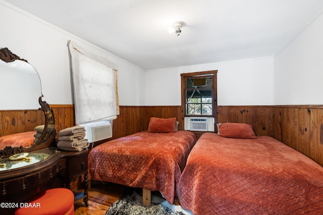 bedroom featuring crown molding, cooling unit, and wood-type flooring