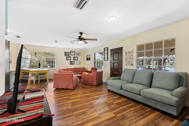 living room featuring hardwood / wood-style floors and ceiling fan