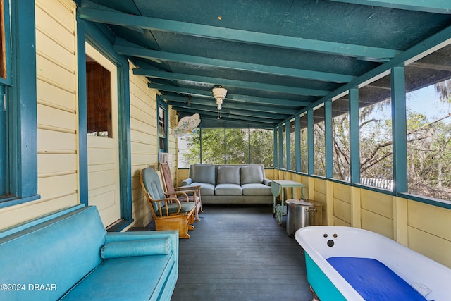 sunroom / solarium featuring plenty of natural light and lofted ceiling