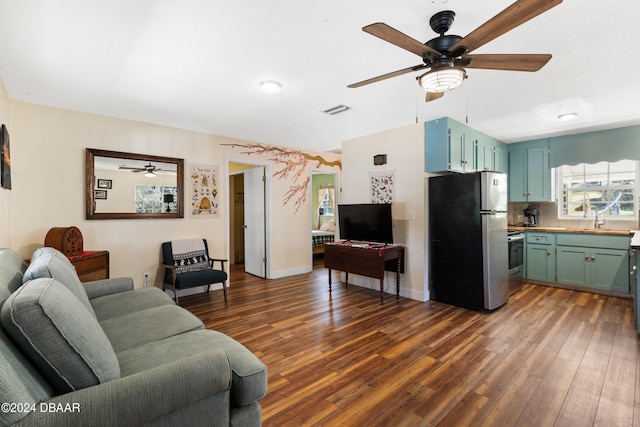 living room with dark hardwood / wood-style flooring and sink