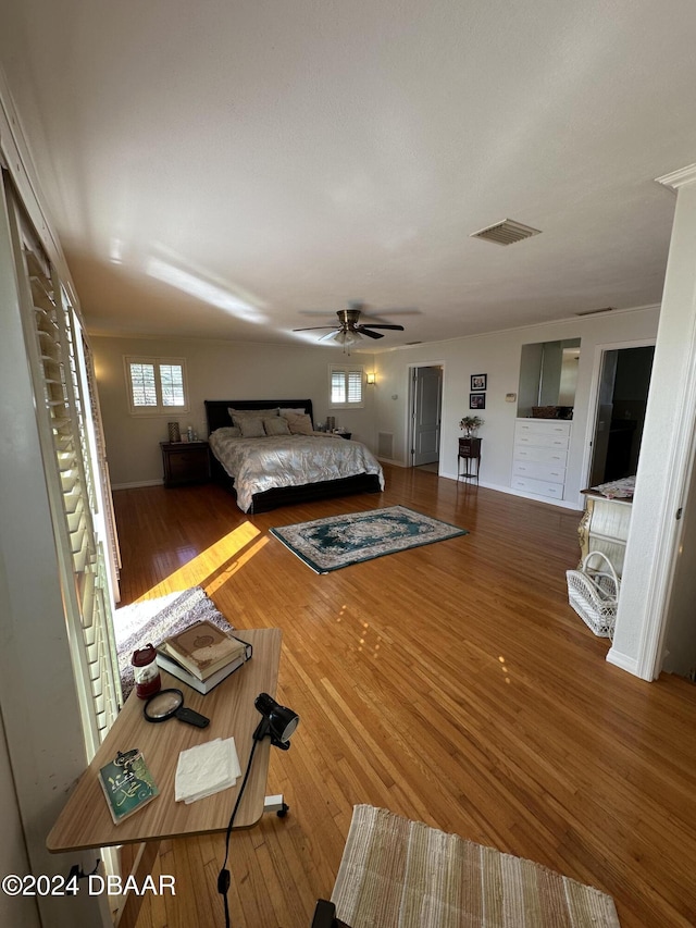 bedroom with hardwood / wood-style floors and ceiling fan