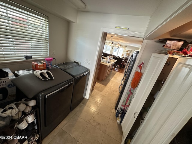 kitchen featuring light tile patterned flooring, independent washer and dryer, and a chandelier