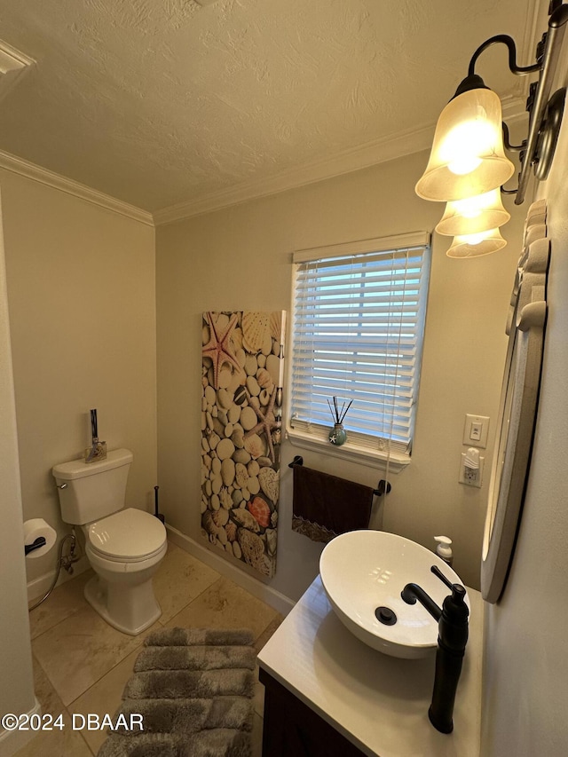 bathroom featuring tile patterned flooring, vanity, toilet, and crown molding