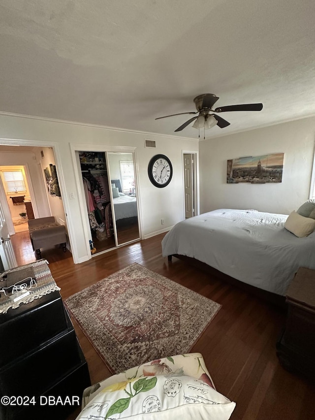 bedroom with a closet, ceiling fan, and dark hardwood / wood-style flooring