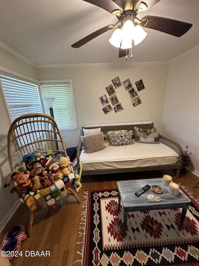 bedroom with ceiling fan, dark hardwood / wood-style floors, and ornamental molding