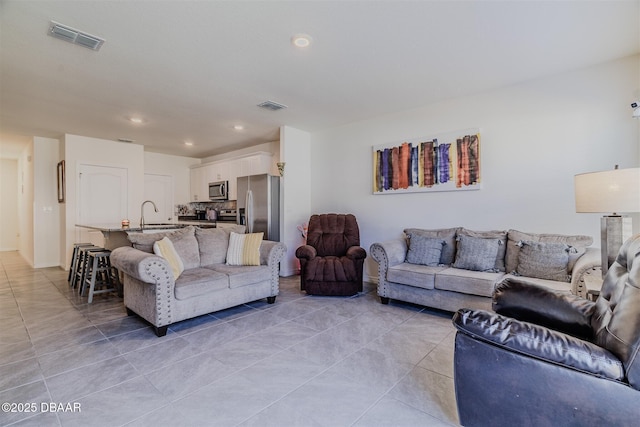 living room with light tile patterned floors and sink