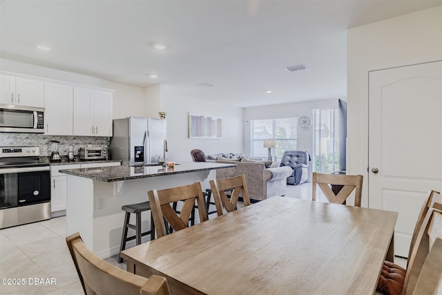 tiled dining space featuring sink