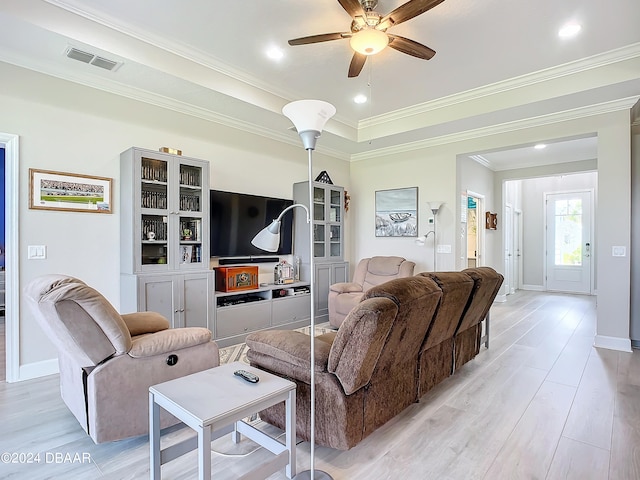 living room with ornamental molding, light hardwood / wood-style flooring, and ceiling fan