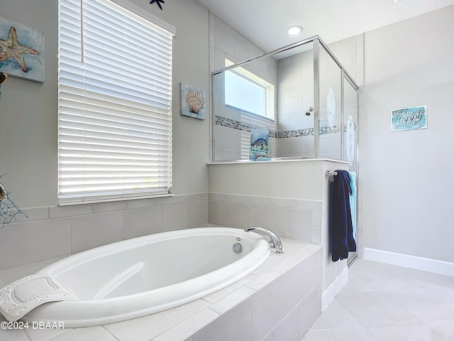 bathroom with independent shower and bath and tile patterned flooring