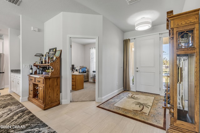 foyer with a textured ceiling