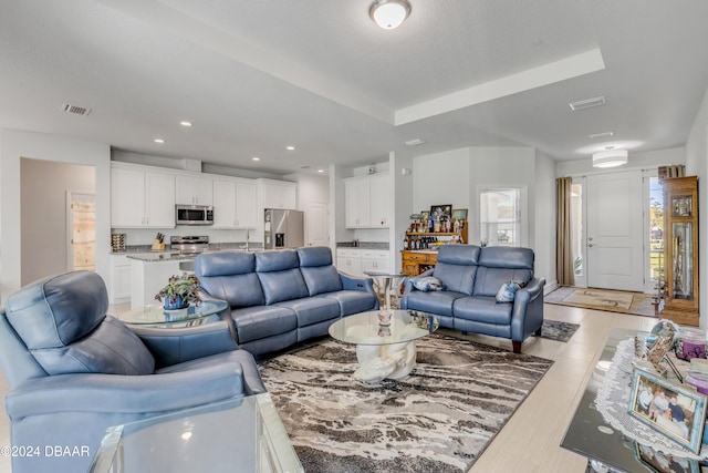 living area with visible vents and recessed lighting