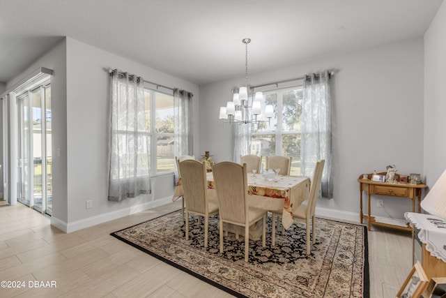 dining area featuring plenty of natural light and a notable chandelier