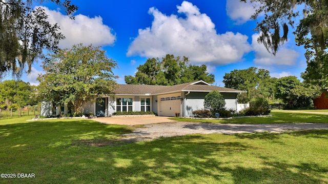 ranch-style house featuring a garage and a front yard