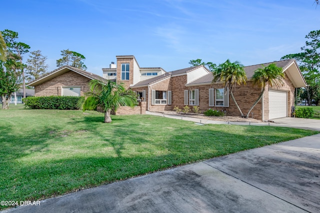 view of front of property featuring a garage and a front lawn