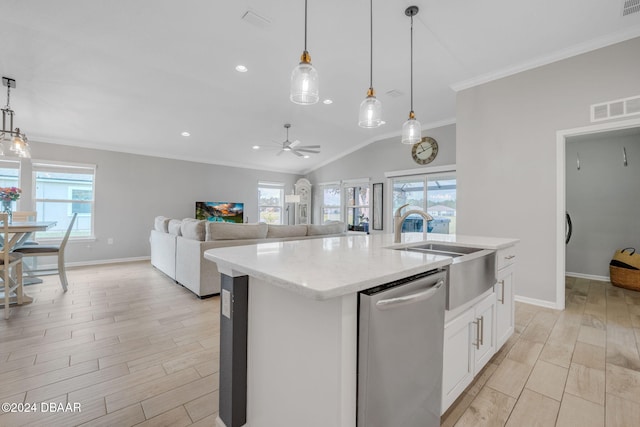 kitchen with hanging light fixtures, vaulted ceiling, light hardwood / wood-style floors, stainless steel dishwasher, and a kitchen island with sink