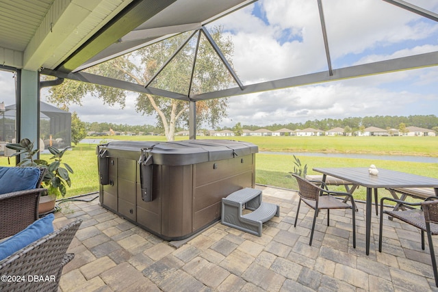 view of patio with a hot tub and a lanai