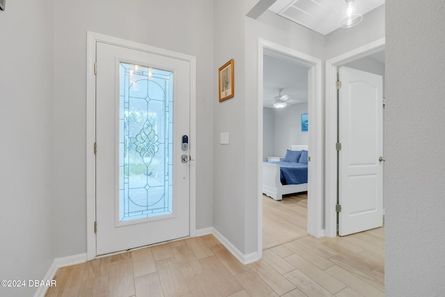 foyer with light wood-type flooring and ceiling fan