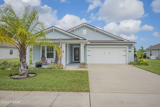 view of front of home featuring a garage and a front yard