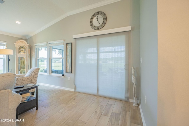 interior space with light hardwood / wood-style floors, lofted ceiling, and crown molding